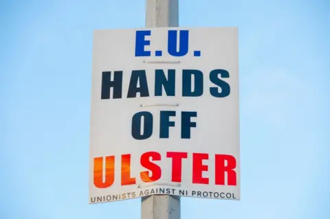 AFP A sign that reads: EU HANDS OF ULSTER - UNIONISTS AGAINST NI PROTOCOL