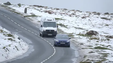 PA A car and van on a Dartmoor road