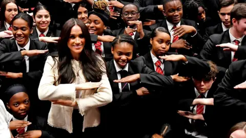 Reuters The Duchess of Sussex meets children at a school in Dagenham