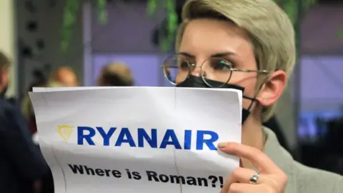 A woman waits at Vilnius airport on 23 May