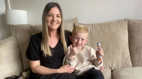 BBC Rachel Williams and her son, Jacob Williams, who is holding an Epipen