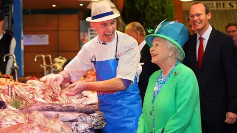 Getty Images The Queen visited the English Market in Cork in 2011, accompanied by Simon Coveney (right)