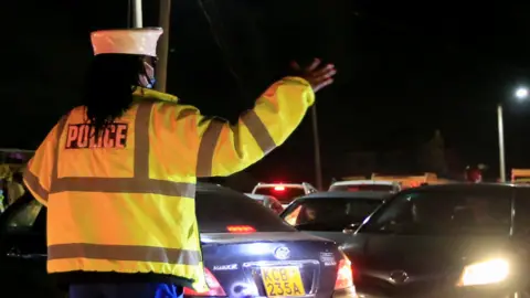 Reuters An officer at a curfew roadblock in Nairobi, Kenya
