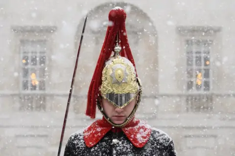 Getty Images A Household Cavalry Guard stands in the blizzard as heavy snow hits Westminster