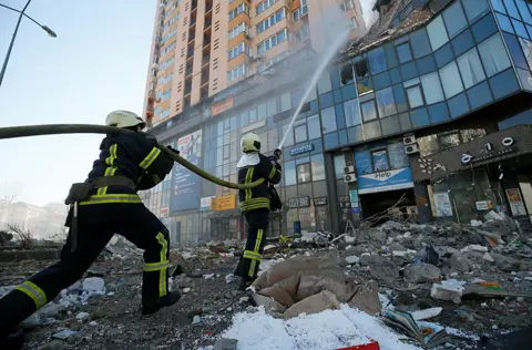 Reuters Firefighters extinguish fire in an apartment building damaged by recent shelling in Kyiv, Ukraine February 26, 2022.