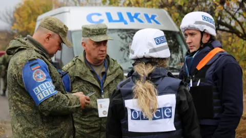 Getty Images Military officials from Joint Centre for Control and Coordination (JCCC) and OSCE observers (11 Oct 19)