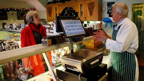 Getty Images Theresa May and local butcher