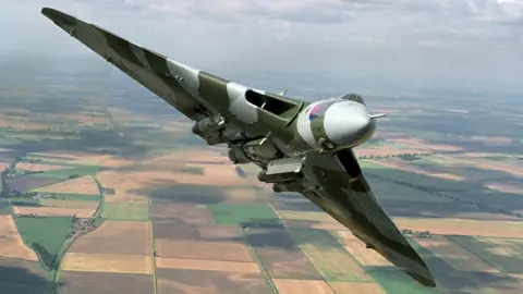 PA Vulcan bomber flying in the air over countryside