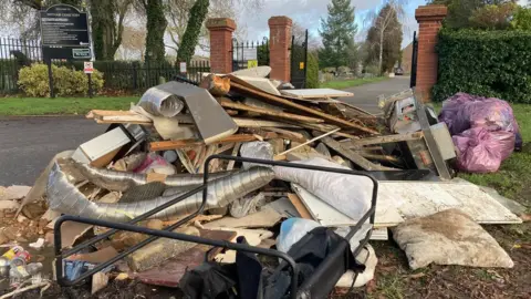 Ian Puckey/BBC Fly tip at Witham Cemetery