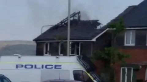 Sharon Hawkings/JustGiving The badly damaged roof of the house following the fire