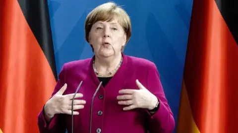 Getty Images German Chancellor Angela Merkel addresses a joint press conference with the French President