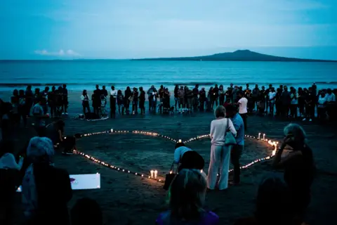 Getty Images Crowds gather on Takapuna beach, for a vigil in memory of the victims of the Christchurch mosque terror attacks, New Zealand, March 2019