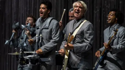 Getty Images David Byrne performing with his band in Milan in 2018