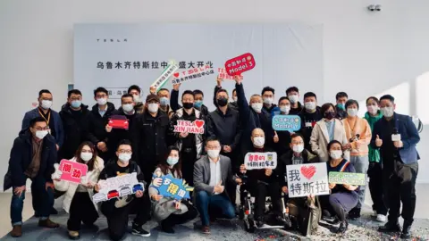 Tesla/Weibo People at opening of Tesla showroom in Xinjiang, China.