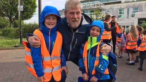 Andrew Powell with his sons Osian, 7, and Morgan, 5.