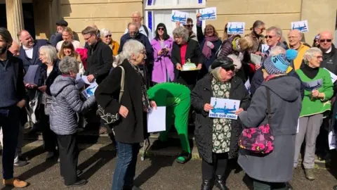 BBC A crowd of people holding "free our croc" signs