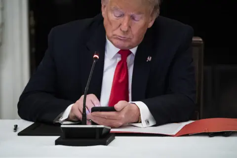 Getty Images Trump using a cellphone