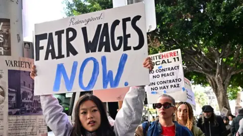 Getty Images Hospitality workers picket outside Hotel Figueroa in downtown Los Angeles on April 5, 2024.