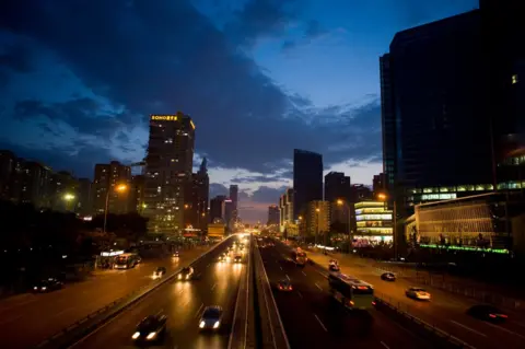 Getty Images Cars roll down a highway cutting through the rapidly developing city July 16, 2007 in Beijing, China.