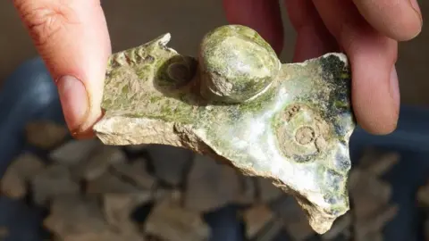 ScottishPower Renewables Piece of a green-glazed face jug