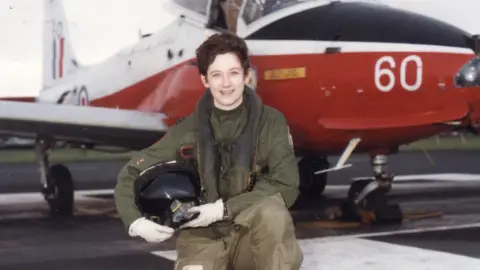 Julie Ann Gibson Julie in front of a plane