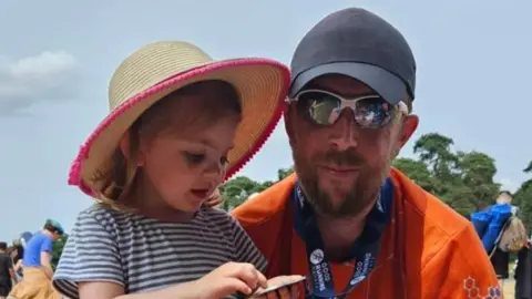 Ryan Thomas/PA Ryan Thomas with his daughter