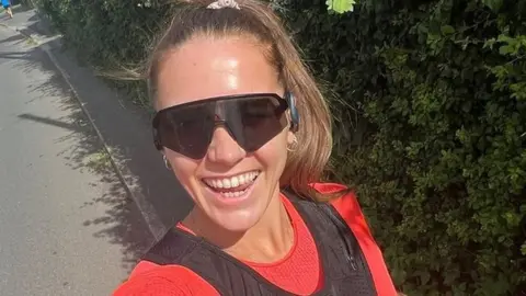 Lucy Davis Lucy Davis taking a selfie while running