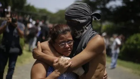 EPA A student hugs a relative after having taken shelter in the parish Divina Misericordia, in Managua, Nicaragua, 14 July 2018