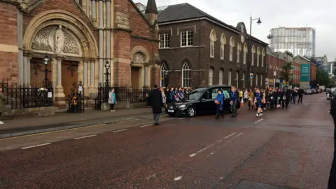 Mourners entering St Patrick's Church on Donegall Street
