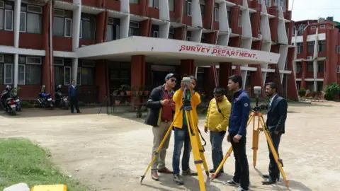 Getty Images Nepali survey team check the equipments in Kathmandu before leaving on an expedition to re-measure the height of Everest