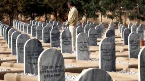 AFP Picture taken 18 May 2007 shows an Eritrean war-veteran visiting a war cemetery in Asmara. Eritrean fighters liberated Asmara in 1991 from Ethiopian forces after a bloody 30-year guerrilla war, finally achieving independence in a 1993 referendum