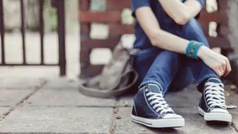 Getty Images Girl sitting on the ground