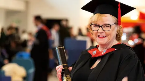 University of Central Lancashire Michelle Lomas in her cap and graduation gown after graduating