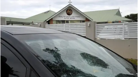 Reuters A smashed car windscreen is pictured outside the Assyrian Christ The Good Shepherd Church after a knife attack that took place during a service the night before, in Wakeley in Sydney, Australia, April 16, 2024