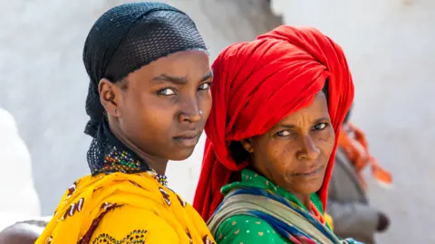Getty Images Two Oromo women are pictured as they take part in a pilgrimage