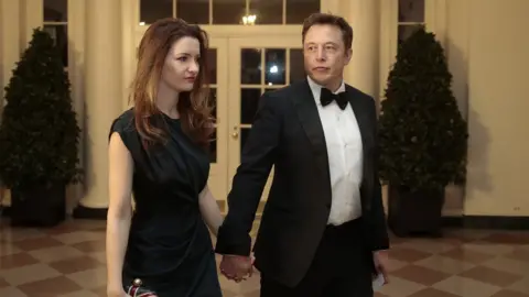 Getty Images Elon Musk and then-wife Talulah Riley arrive at the White House in February 2014