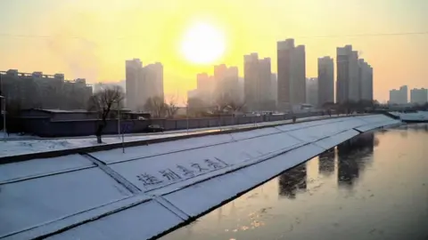 BBC Chinese characters in the snow on the banks of the Tonghui river in Beijing read "Goodbye Li Wenliang!"