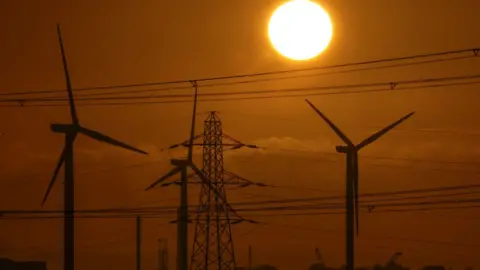 Getty Images Wind turbine and pylons