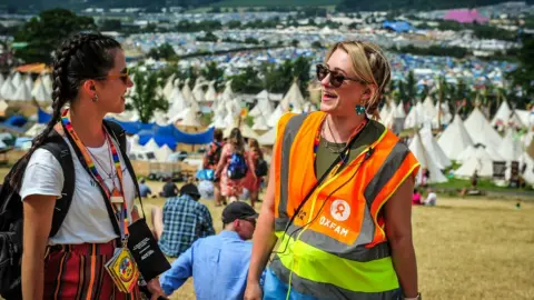 Oxfam Volunteer stewards, Andrada Conti and Cathye Snell at Glastonbury Festival site