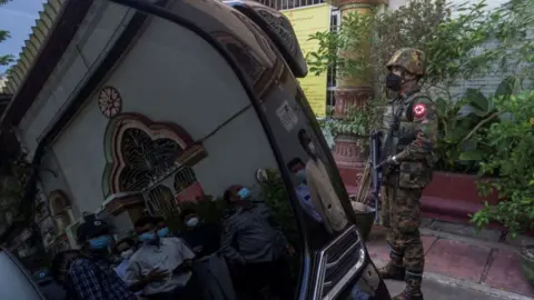 Getty Images A soldier standing guard outside a temple in Yangon in the aftermath of the coup, 2 February 2021