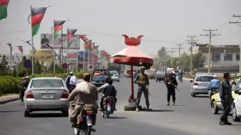 AFP Afghan policemen stand guard at a checkpoint ahead of parliamentary election in Kandahar on October 18, 2018.