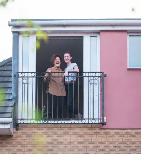 Nicky Ebbage Amelia and H on their balcony in Bristol