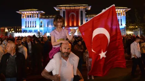 NECATI SAVAS/EPA-EFE/REX/Shutterstock Supporters gather to hear Turkish President Recep Tayyip Erdogan give an address after winning re-election in Turkey's run-off vote, at the Presidential Palace in Ankara, Turkey, 28 May