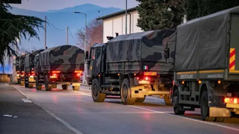 Reuters A convoy of army trucks carrying coffins of Covid-19 victims in Bergamo