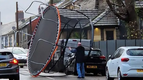 UGC Giant trampoline blown into road