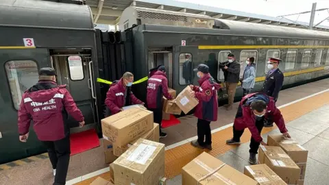 Barcroft Media/Getty Images Medical workers leave for the Ejin Banner