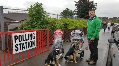 Twitter/@Thefpl_vet Screen grab of tweet by @Thefpl_vet of a man with two babies in strollers and two dogs