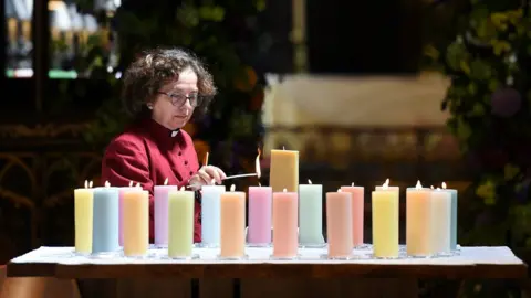 Getty Images Candles lit in Manchester Cathedral