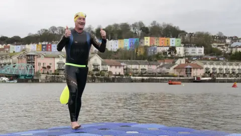 Andrew Matthews David Quartermain coming out of the water with his thumbs up