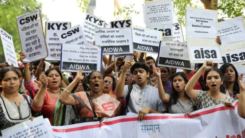 EPA Indian activists hold placards that read in Hindi "Indian Government take stern action against the rapists" as they protest against the alleged rapes Uttar Pradesh and Jammu and Kashmir, in New Delhi, India, 12 April 2018.